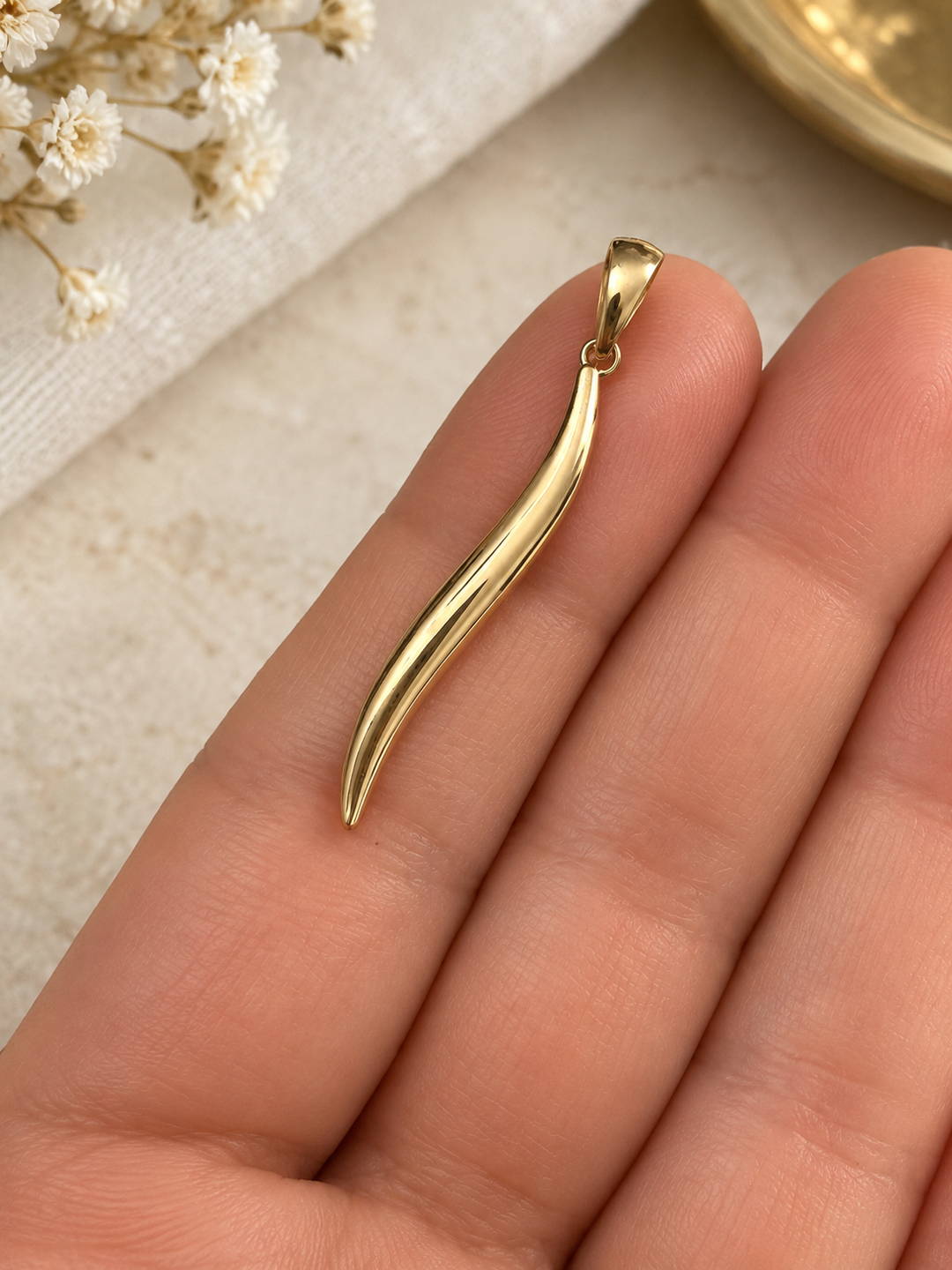 Sholeh Anhänger aus 18k Gelbgold mit hochglanzpolierter geschwungener Oberfläche auf der Hand