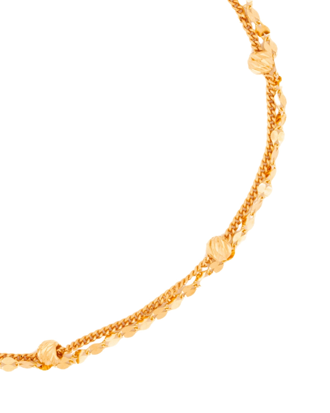 Detailaufnahme der facettierten Goldkugeln auf der zweisträngigen Kette