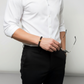 Elegantes Herrenarmband aus mattschwarzen Natursteinperlen mit goldfarbener Akzentperle, stilvoll kombiniert zu weißem Hemd und schwarzer Stoffhose – modernes Schmuckaccessoire für Business und Alltag.