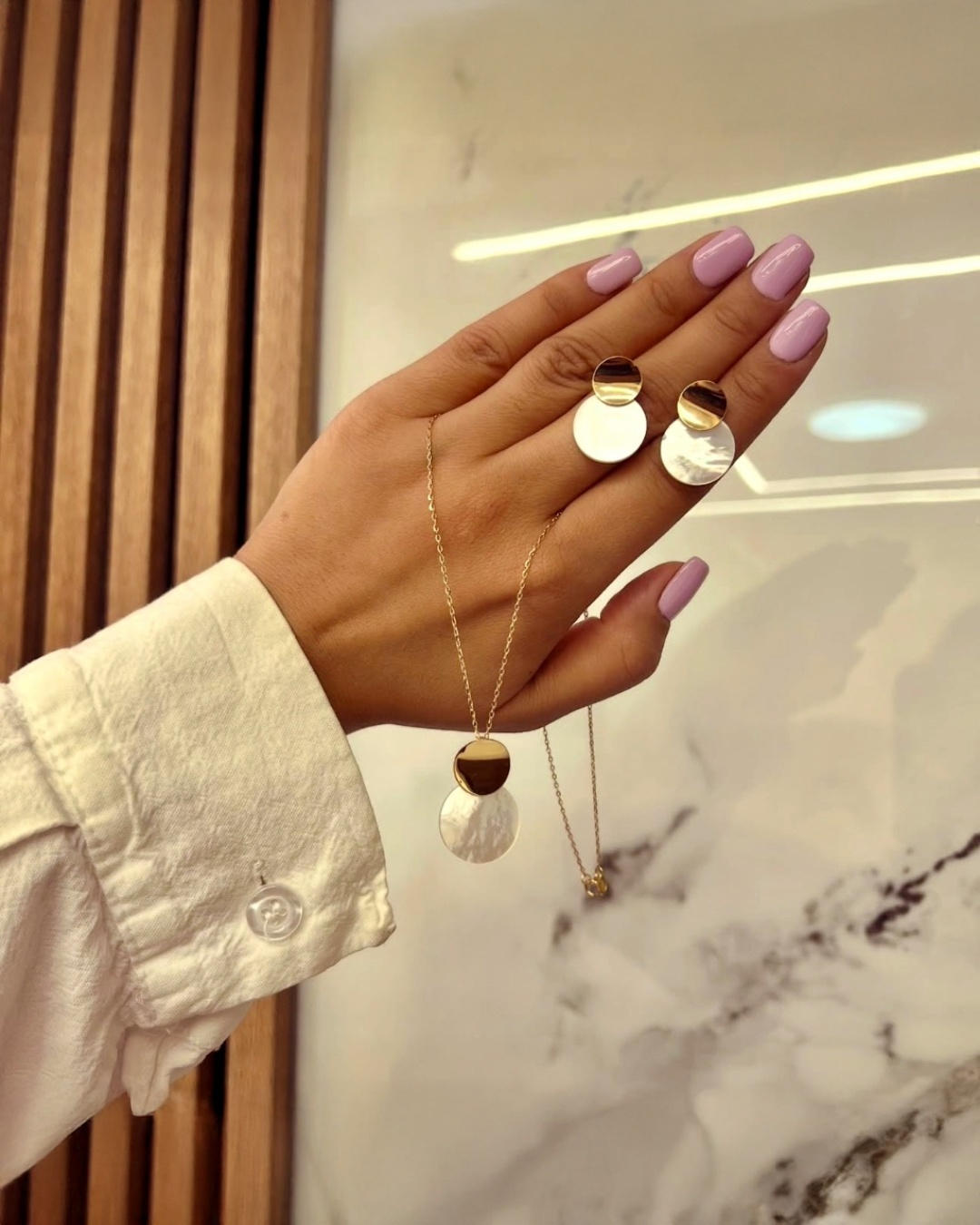 18k Gelbgold Halskette und Perlmutt-Ohrringe auf der Hand präsentiert, moderner eleganter Schmuck