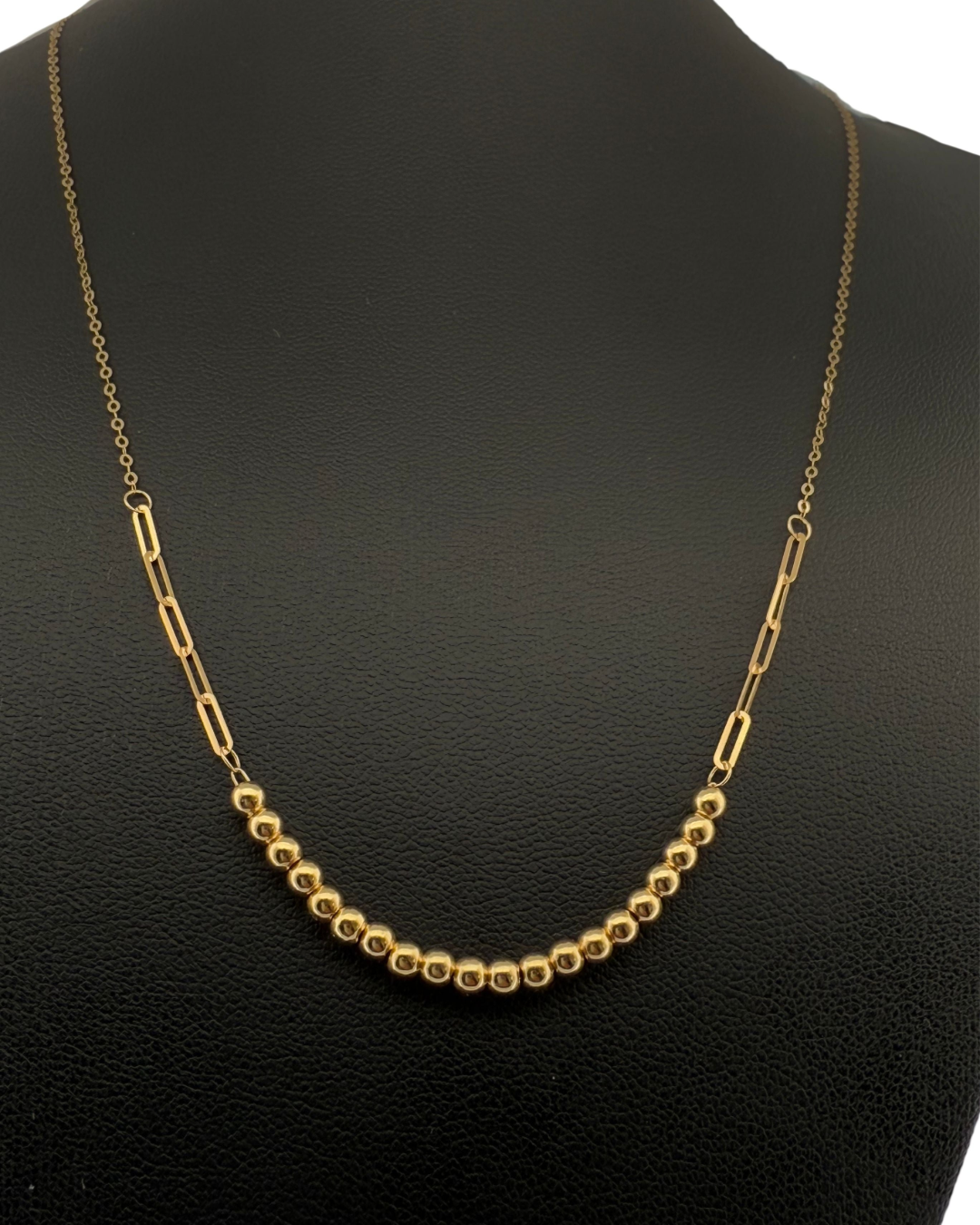 Goldperlenkette auf schwarzer Präsentationsbüste – polierte Kugeln und längliche Glieder aus 18k Gelbgold, Modell Zanjir Tala-e Morvarid