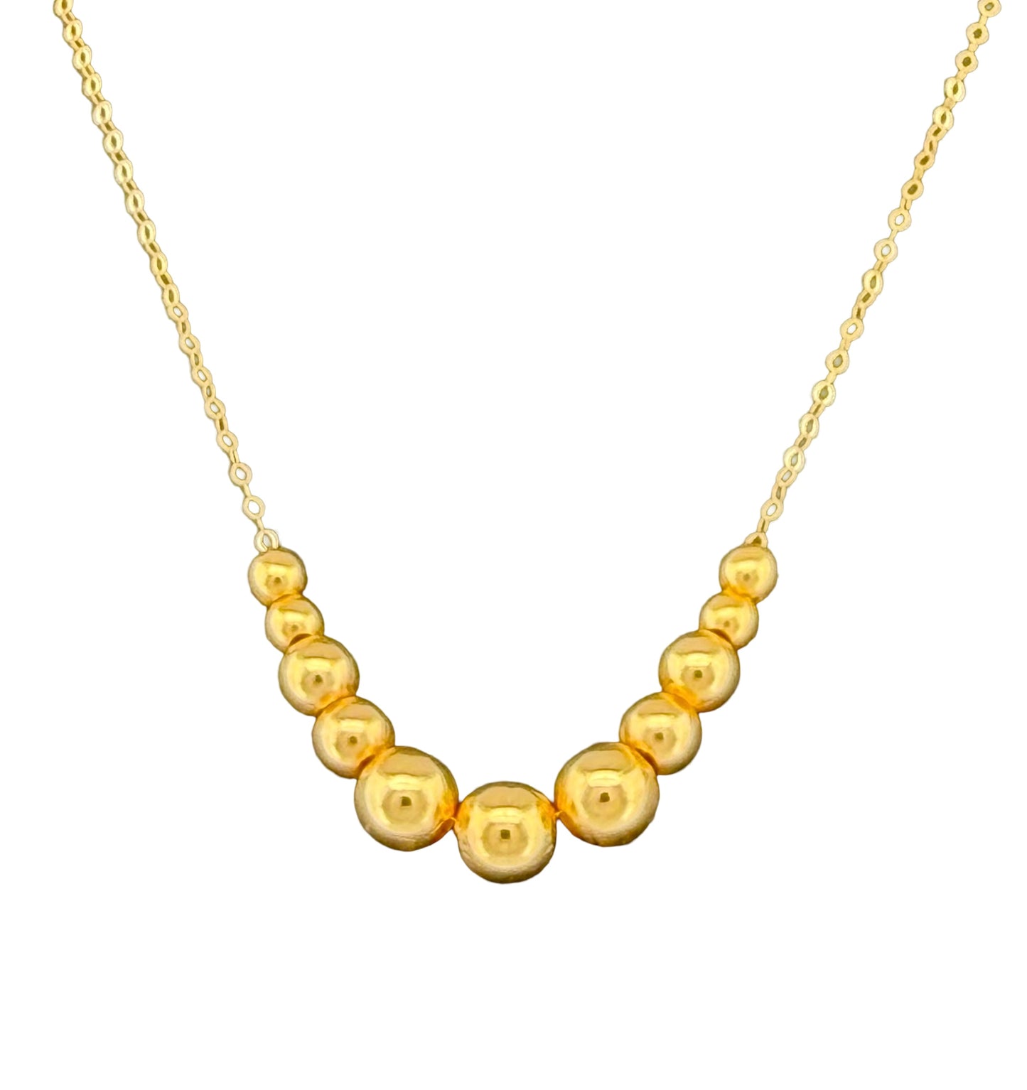 Detailaufnahme der abgestuften Goldkugeln an einer 18k Goldhalskette