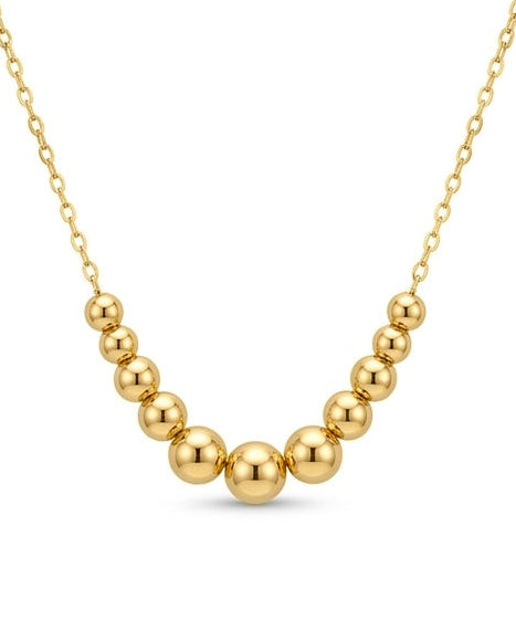 Detailaufnahme der abgestuften Goldkugeln an einer 18k Goldhalskette