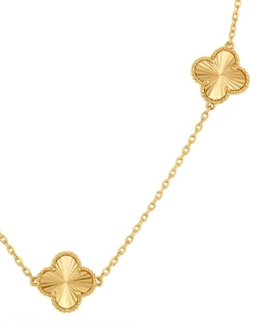 Filigrane Halskette aus 18k Gelbgold mit drei diamantierten Kleeblättern auf einer Schmuckbüste.