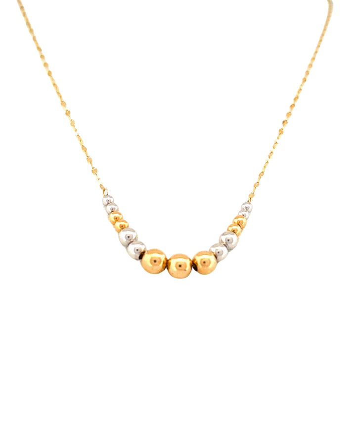 Feine Halskette aus 18k Gelb- und Weissgold mit abgestuften Goldkugeln, freigestelltes Produktbild