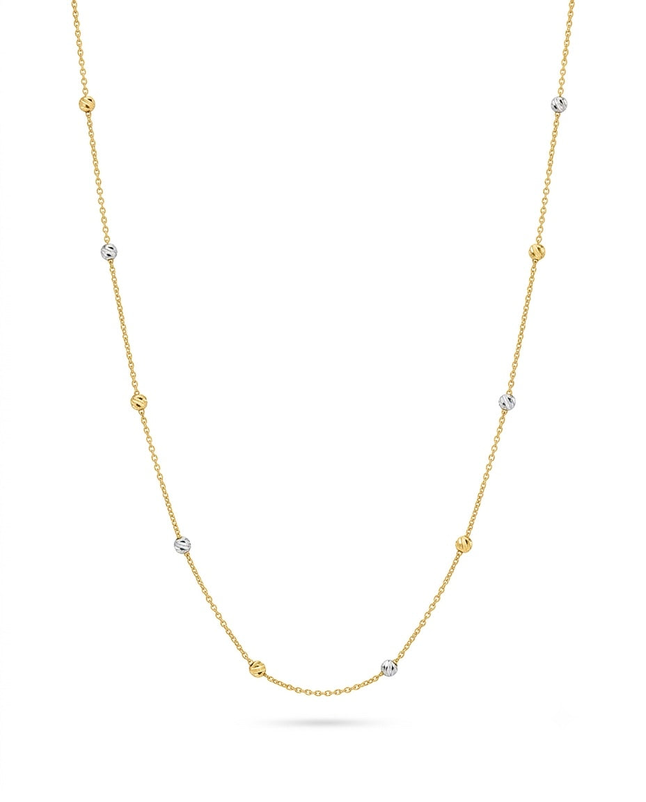Feine Halskette aus 18-karätigem Gelbgold mit zarten, gleichmässig verteilten Kugel-Elementen in Gelb- und Weissgold. Die diamantierten Kugeln reflektieren das Licht dezent und verleihen der filigranen Kette einen eleganten, luftigen Look. Freigestellt vor weissem Hintergrund.