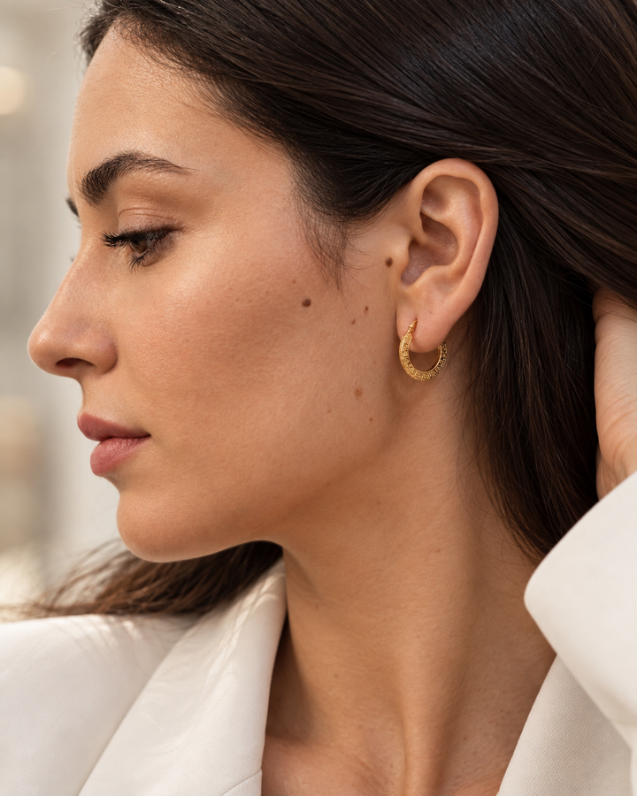Elegante 18 Karat Gelbgold-Creole mit strukturierter Oberfläche am Ohr getragen. Zeitloser 750er Goldohrring für Damen in hochwertiger Verarbeitung – stilvolle Seitenansicht mit natürlichem Tragebild.