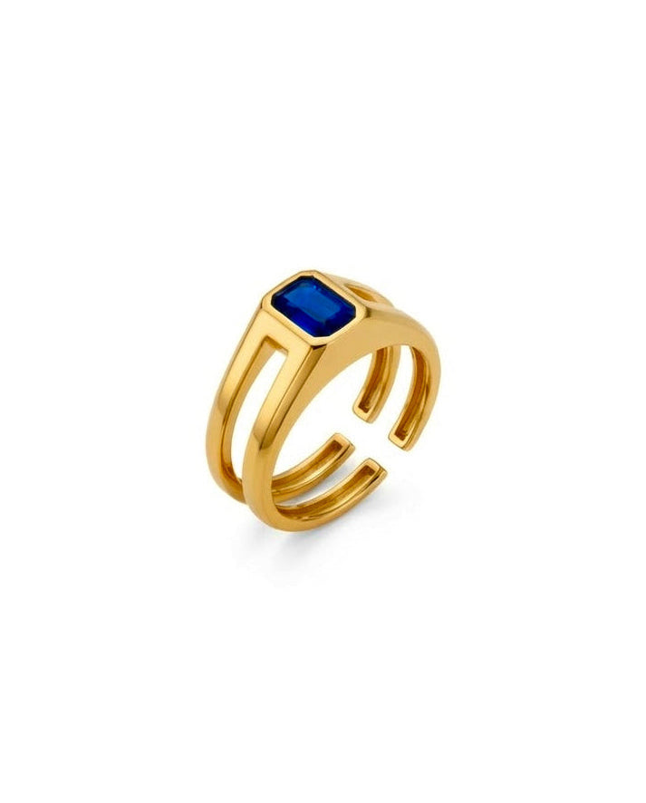 Geometrischer 18k Gelbgold Ring mit saphirblauem Zirkonia auf weißem Hintergrund