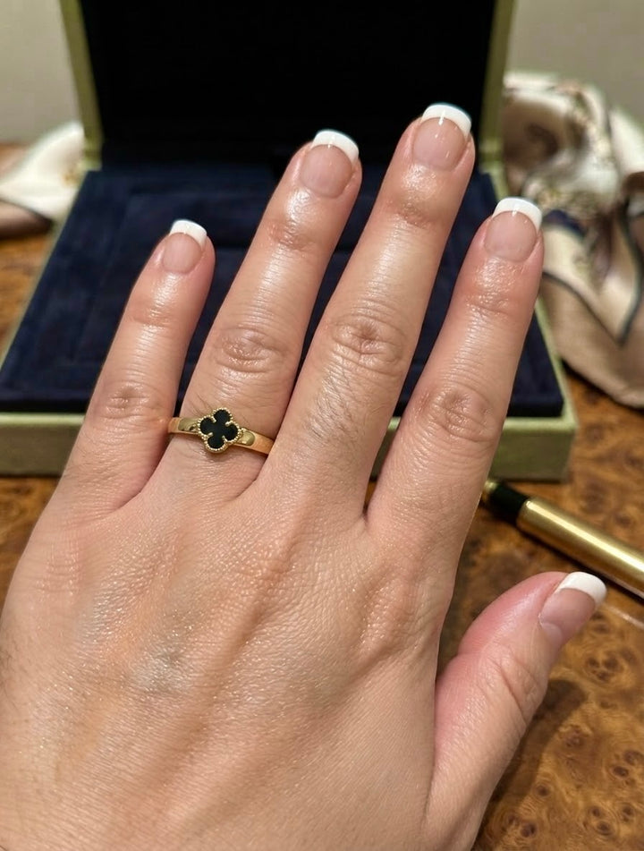 Onyx Ring aus 18k Gelbgold mit schwarzem Kleeblatt am Finger getragen