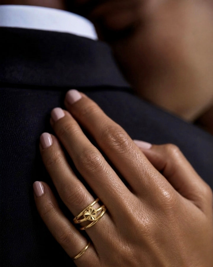 Frau trägt den Ring Tak Del aus 18k Gelbgold mit filigranem Herzmotiv am Finger
