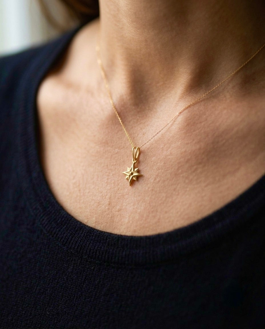 Elegante 18 Karat Gelbgold-Halskette mit filigranem Polarstern-Anhänger, getragen am Hals. Der fein gearbeitete Stern symbolisiert Orientierung, Hoffnung und den richtigen Weg. Zeitloser Goldschmuck für Damen, handgefertigt und perfekt für den Alltag oder besondere Anlässe.